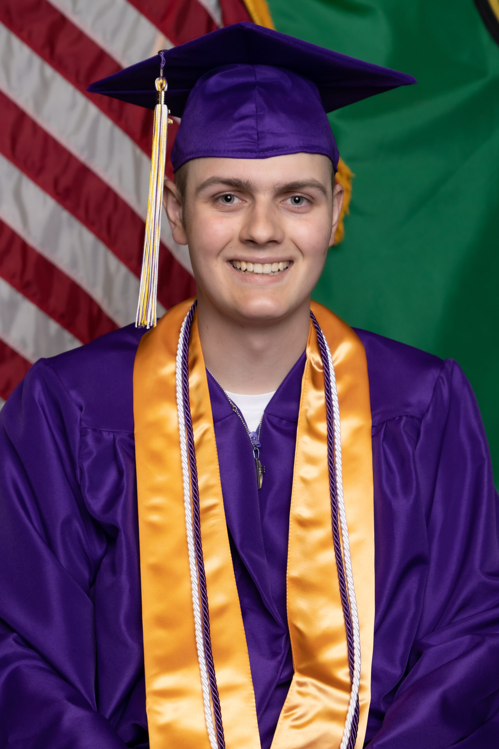 Cole in purple and yellow cap and gown