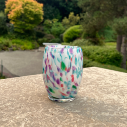 Candle votive pink, green, blue on white background